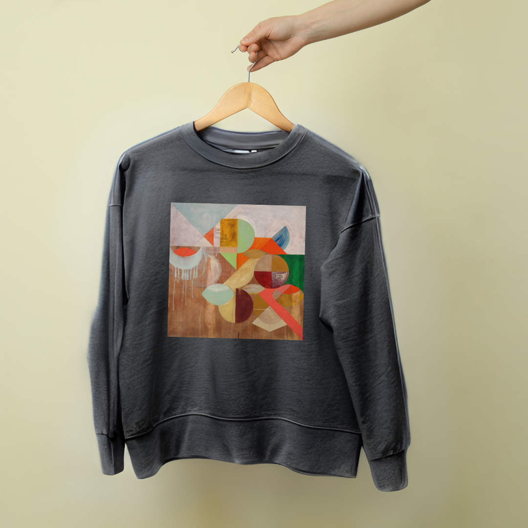 A gray sweatshirt with a geometric pattern artwork on the front, displayed on a hanger against a beige background.