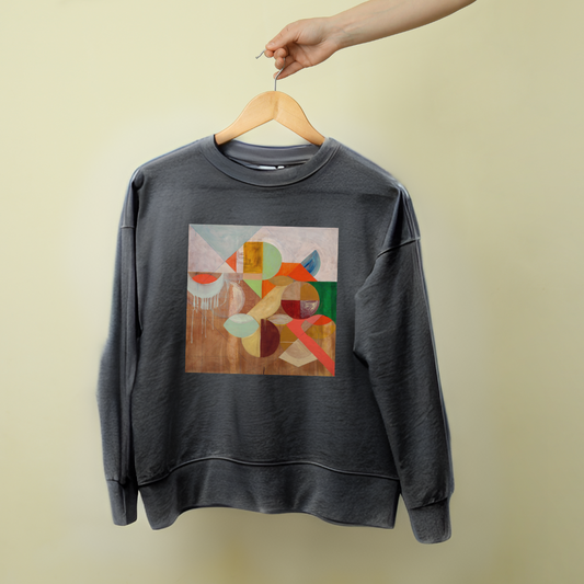 A gray sweatshirt with a geometric pattern artwork on the front, displayed on a hanger against a beige background.