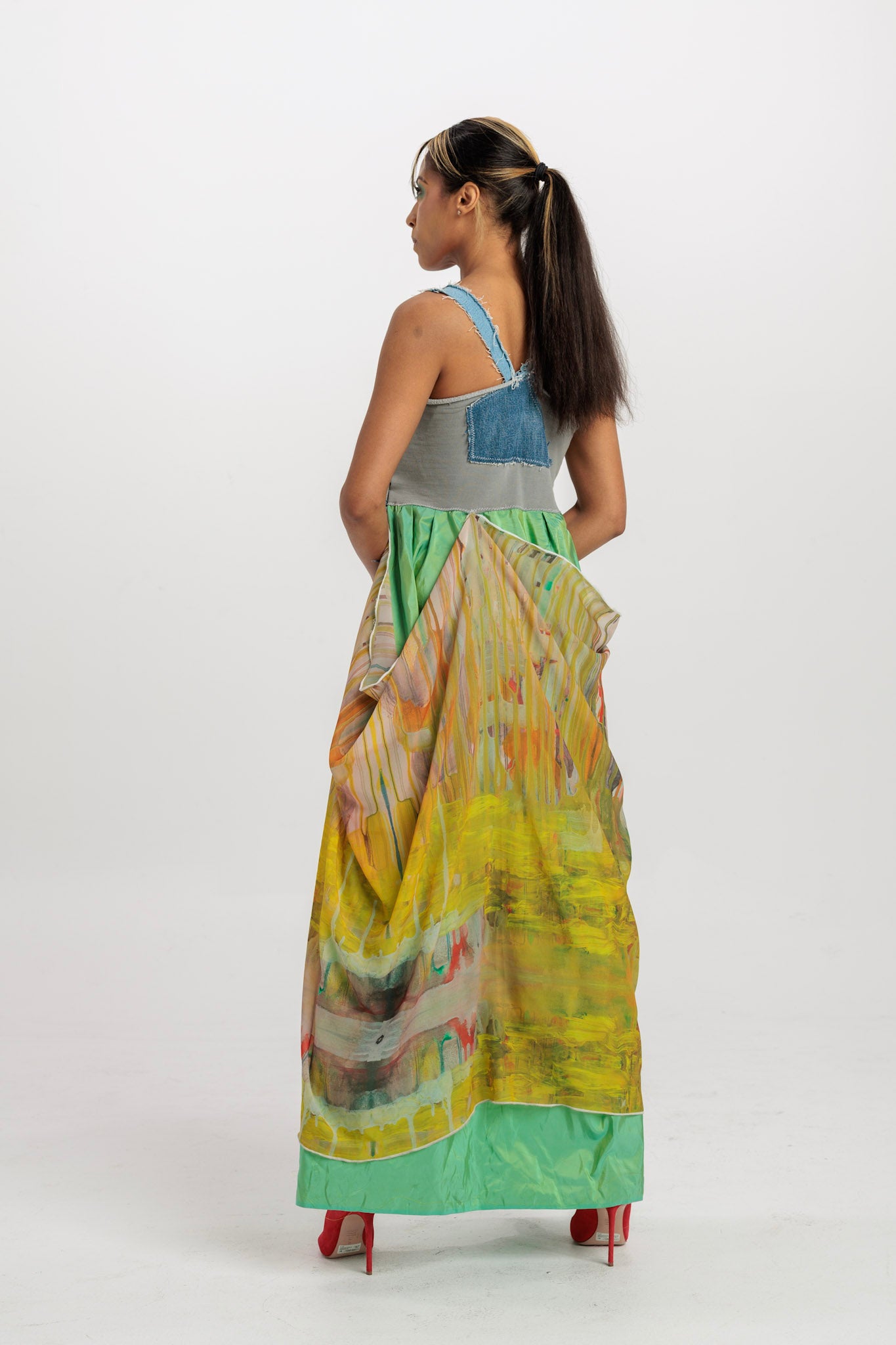 Back view of upcycled denim and silk dress, showing open panel work and flowing silk skirt, handmade by Sarah Tremain.