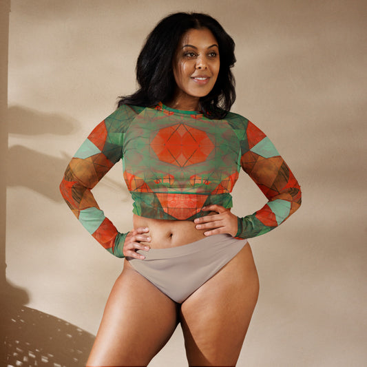 A woman wearing a multicolored geometric patterned crop top with long sleeves.