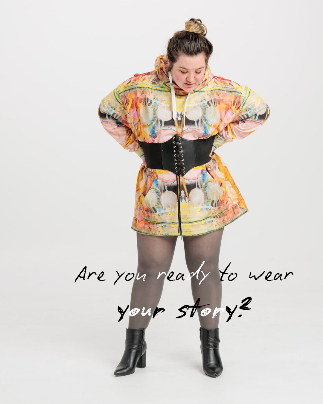 Person wearing a colorful outfit with text 'Are you ready to wear your story?'