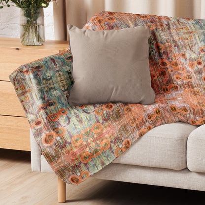 Sofa with a colorful patterned throw and a beige pillow in a living room setting.