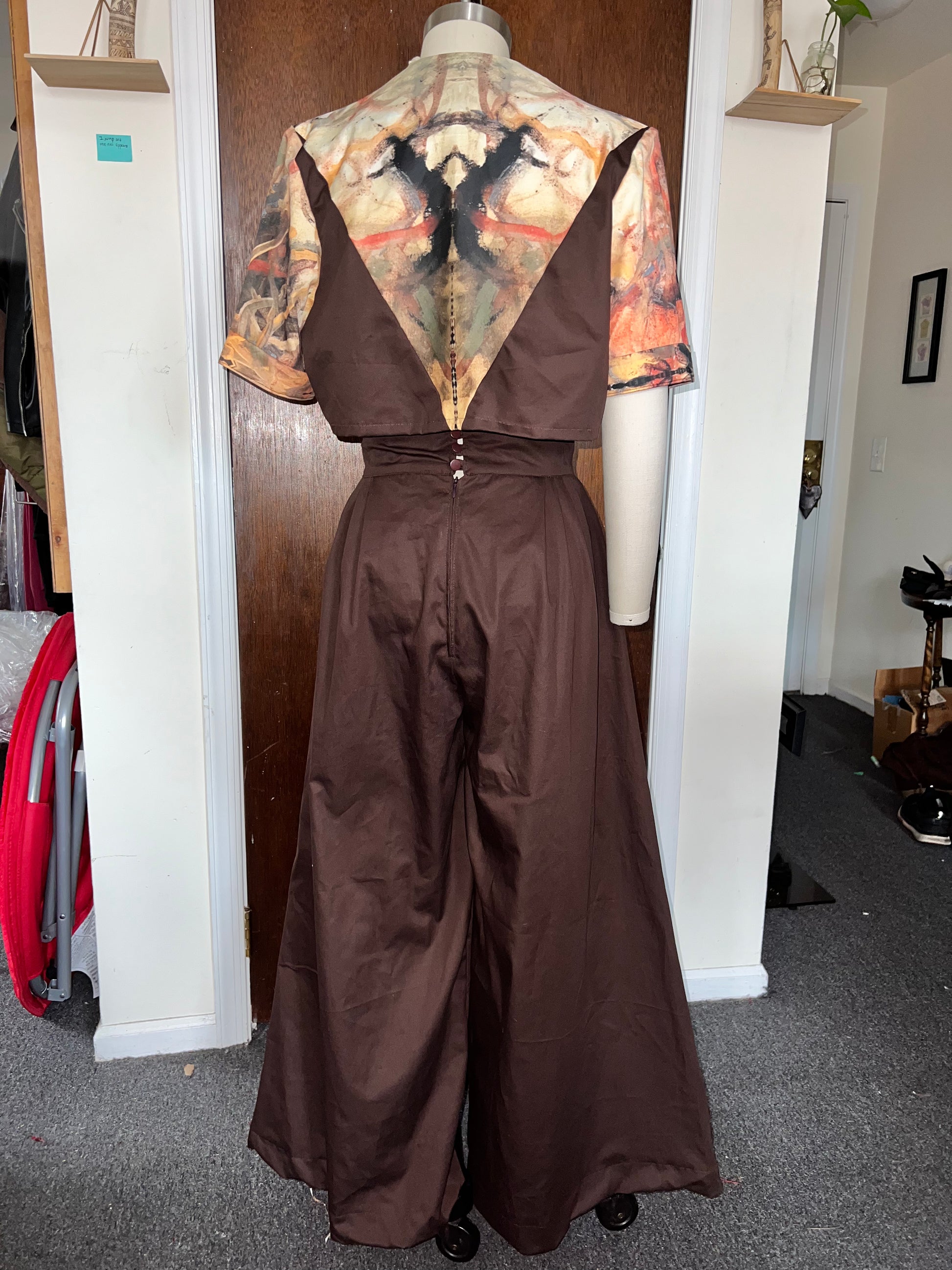 Brown custom set with abstract top on a mannequin in a room setting.
