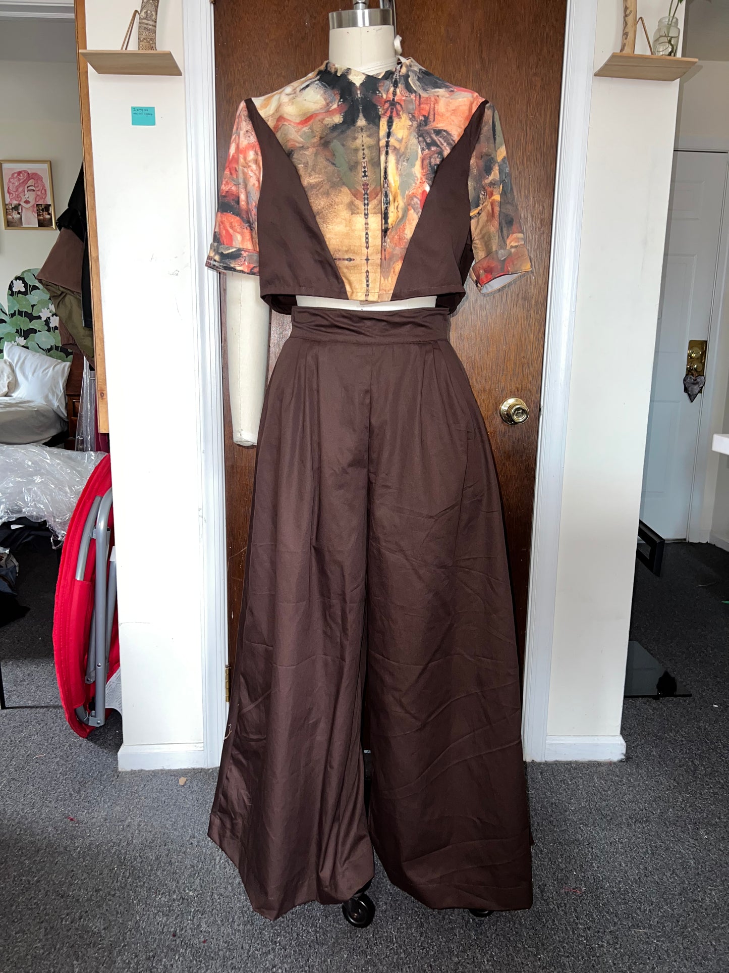 Brown custom set on a mannequin against a door in a room.