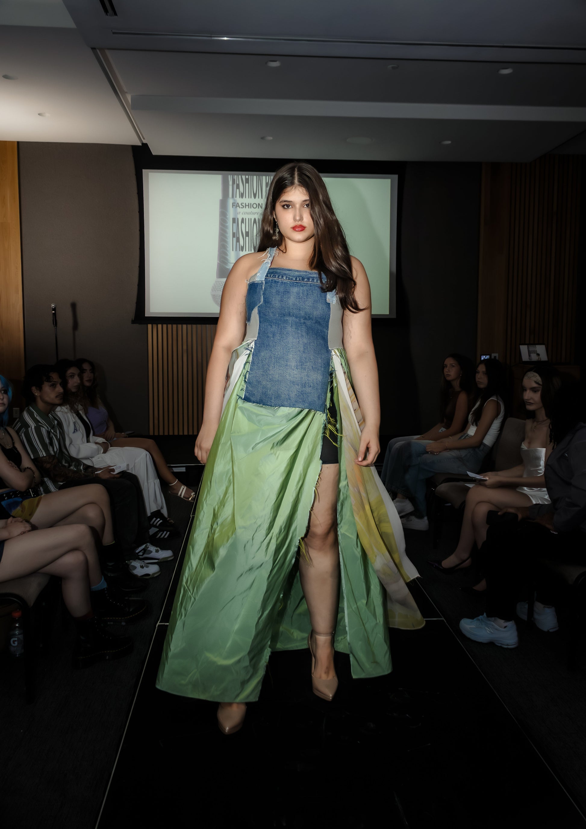 Model walking on a runway wearing upcycled denim and silk dress, skirt moving in the wind, from Sarah Tremain’s 'You Have Everything You Need' collection.