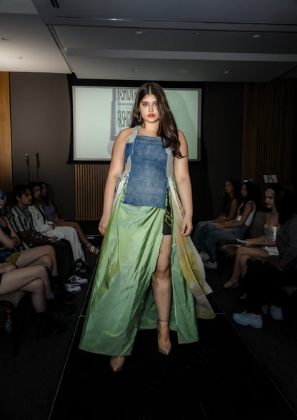 Model walking on a runway wearing upcycled denim and silk dress, skirt moving in the wind, from Sarah Tremain’s 'You Have Everything You Need' collection.