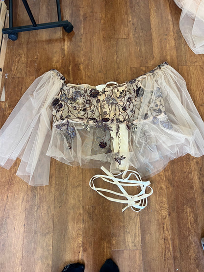 Upcycled Wedding Dress turned corset top laying on wood floor